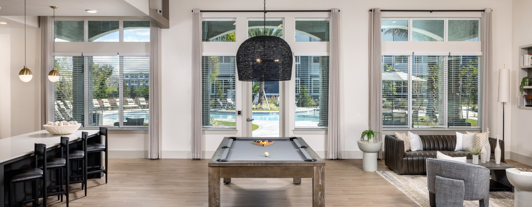 pool table with a large light fixture above it
